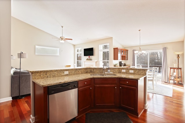 kitchen featuring dishwasher, open floor plan, a sink, and lofted ceiling