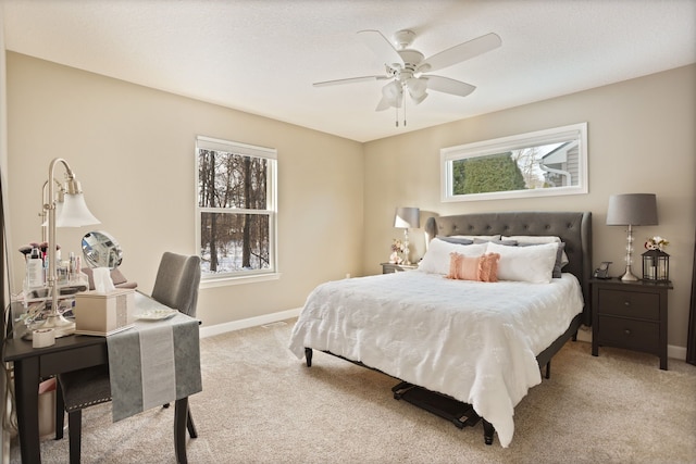 bedroom with a textured ceiling, baseboards, a ceiling fan, and light colored carpet