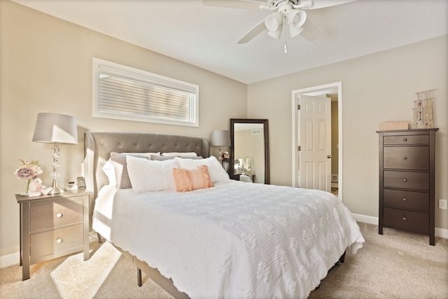 bedroom with light carpet, ceiling fan, and baseboards