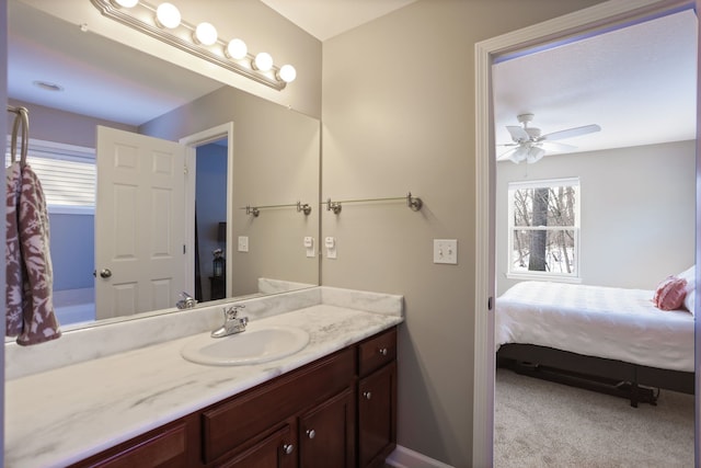 bathroom with ensuite bathroom, vanity, and a ceiling fan