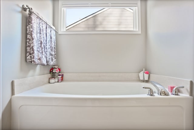 full bathroom with a garden tub and a wealth of natural light