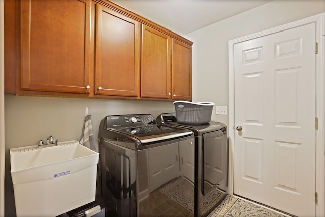 laundry area featuring a sink, light tile patterned floors, washing machine and clothes dryer, and cabinet space