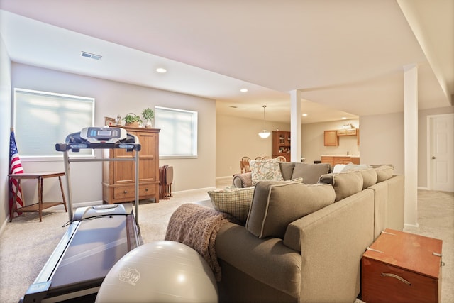 living room featuring recessed lighting, visible vents, baseboards, and light colored carpet