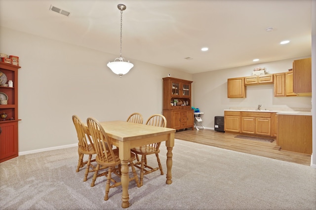 dining space featuring light carpet, baseboards, visible vents, and recessed lighting