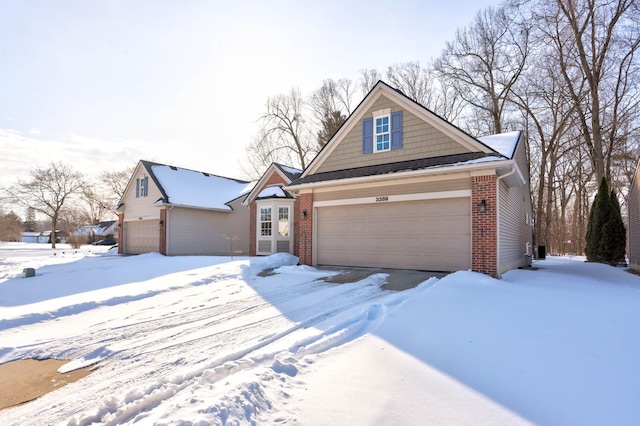 view of front of house featuring a garage and brick siding