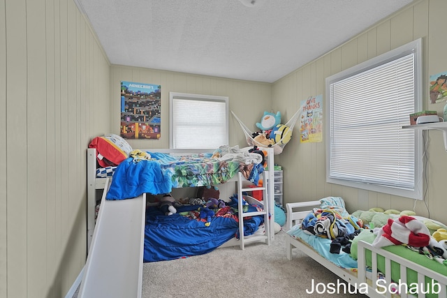 bedroom with carpet and a textured ceiling