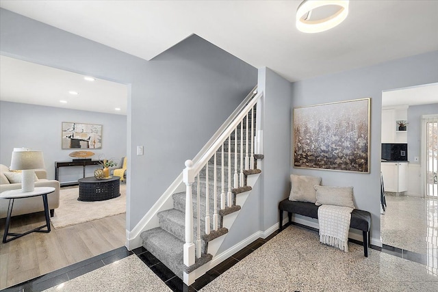 staircase with baseboards and recessed lighting