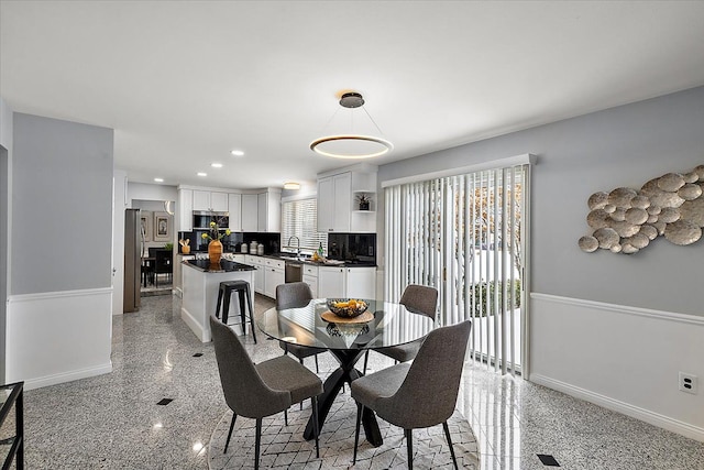 dining space featuring recessed lighting, granite finish floor, and baseboards