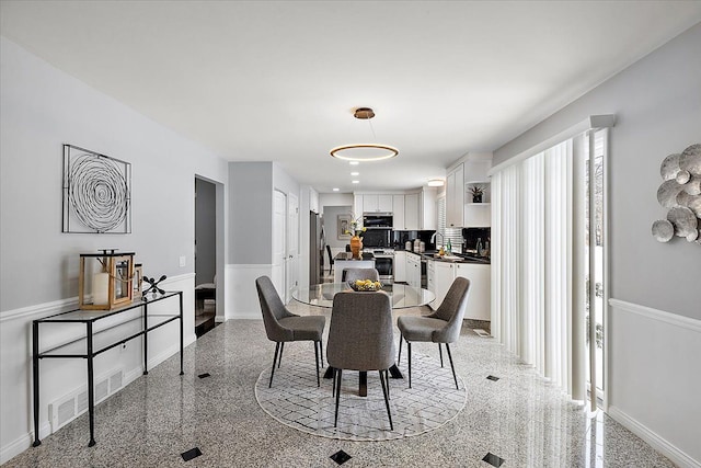 dining area featuring granite finish floor and baseboards