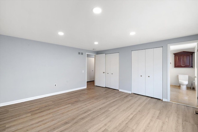 unfurnished bedroom with recessed lighting, visible vents, baseboards, light wood-style floors, and multiple closets