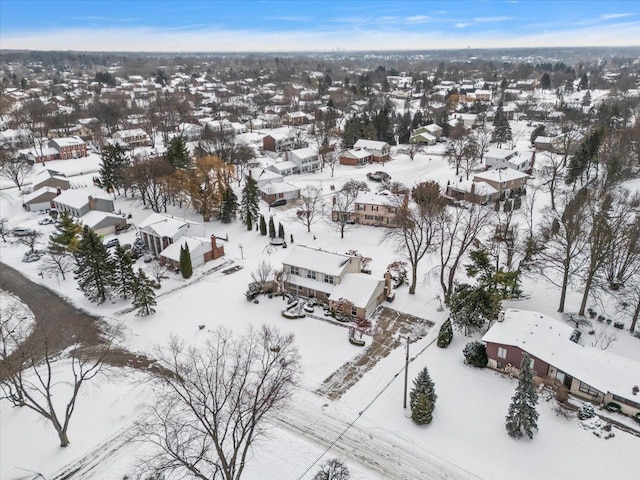 snowy aerial view with a residential view