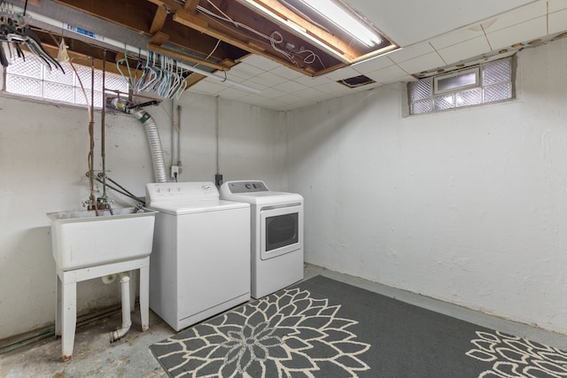 laundry room with washer and dryer, laundry area, and a sink