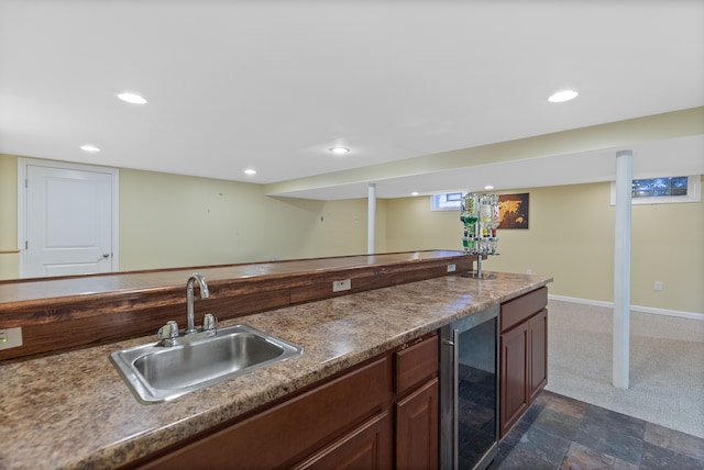 kitchen with wine cooler, a sink, baseboards, and recessed lighting