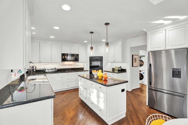 kitchen with black appliances, stacked washing maching and dryer, white cabinetry, and dark wood finished floors