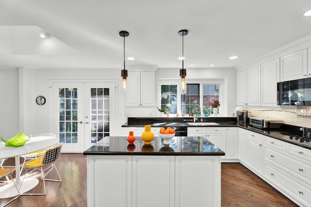 kitchen with dark wood-style flooring, black microwave, a sink, and french doors