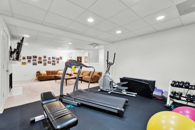 workout room with a paneled ceiling, baseboards, and recessed lighting