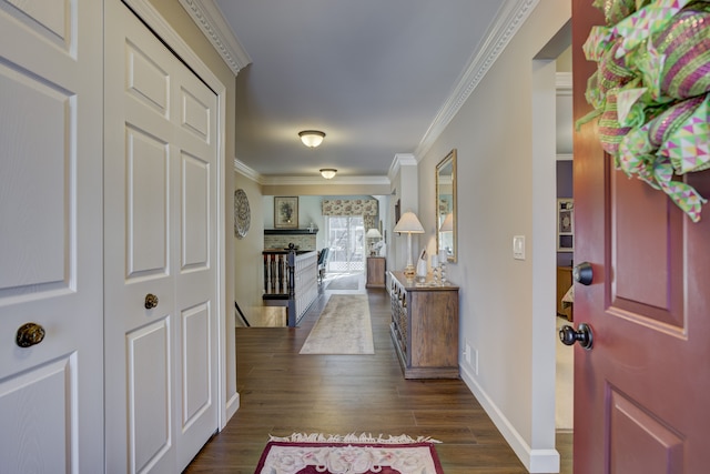 entryway featuring baseboards, dark wood finished floors, and crown molding