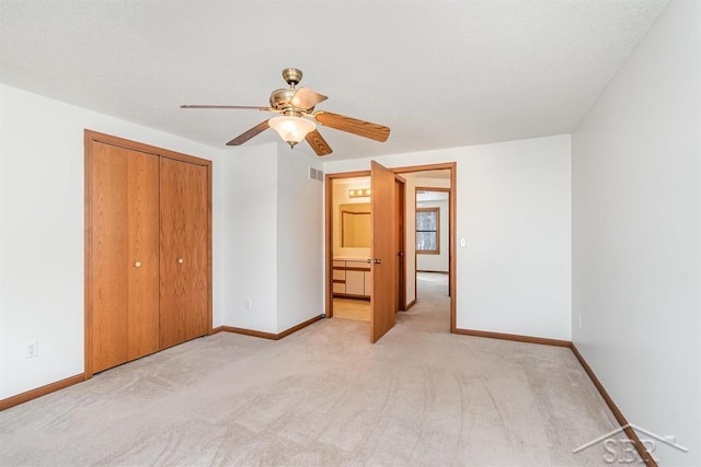 unfurnished bedroom with light carpet and baseboards