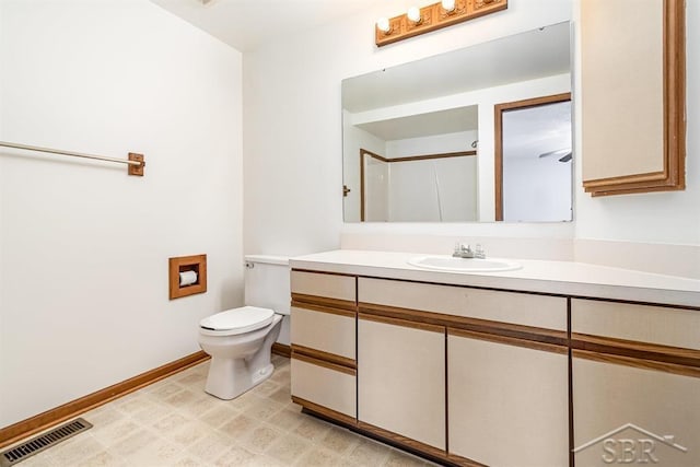 full bathroom featuring toilet, baseboards, visible vents, and vanity