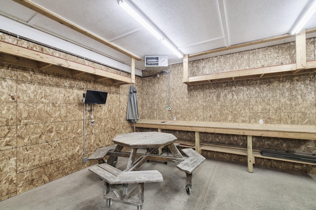 interior space with concrete flooring, a workshop area, and visible vents