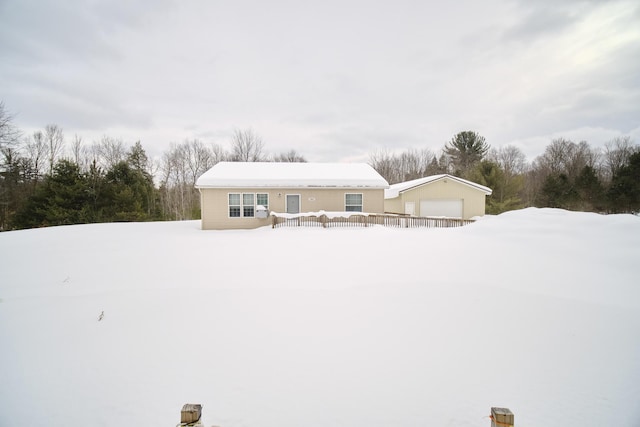 view of front of house featuring a detached garage and a wooden deck