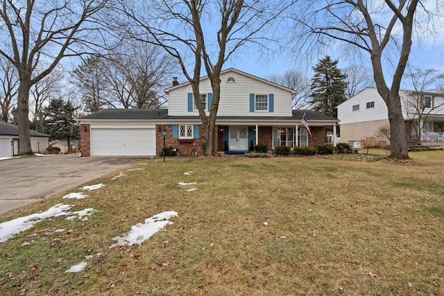 traditional-style home with brick siding, a chimney, an attached garage, a front yard, and driveway