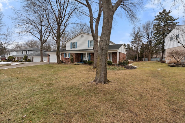 traditional-style house featuring an attached garage, driveway, a front yard, and brick siding