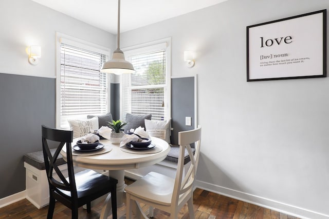 dining area with dark wood-style flooring and baseboards