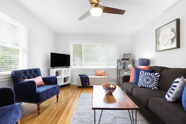 living room with a healthy amount of sunlight, light wood finished floors, and a ceiling fan