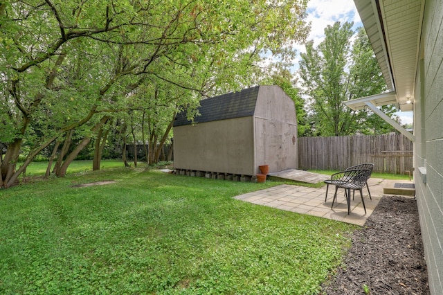 view of yard featuring an outbuilding, a shed, a patio area, and a fenced backyard