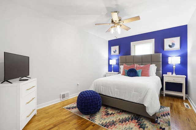 bedroom featuring baseboards, visible vents, and light wood-style floors