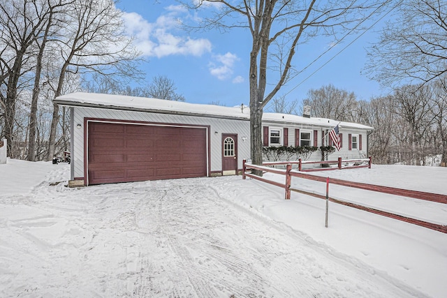 view of front facade featuring an attached garage and fence