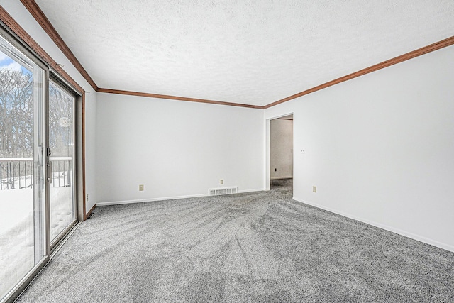 carpeted spare room featuring baseboards, a textured ceiling, visible vents, and crown molding