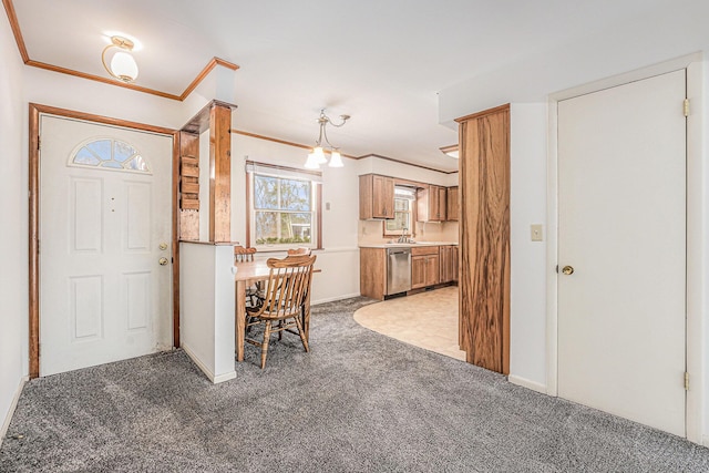 foyer featuring crown molding and light colored carpet