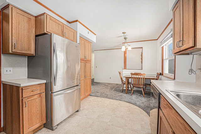 kitchen with light colored carpet, appliances with stainless steel finishes, ornamental molding, light countertops, and a sink