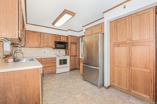 kitchen featuring black microwave, a sink, white range with electric stovetop, freestanding refrigerator, and light floors