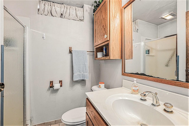 full bath with toilet, vanity, a shower stall, and visible vents