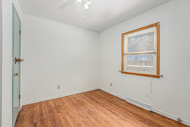 spare room featuring ceiling fan, light wood-style flooring, visible vents, and baseboards