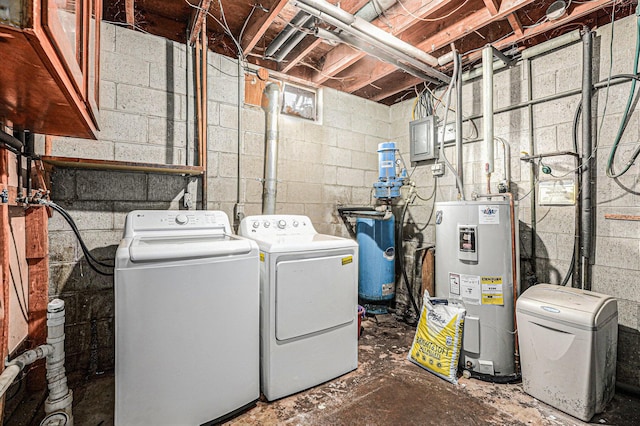 clothes washing area with electric panel, laundry area, water heater, and washing machine and clothes dryer