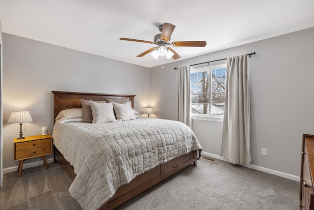 carpeted bedroom featuring a ceiling fan, visible vents, and baseboards