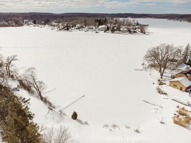 snowy aerial view with a water view