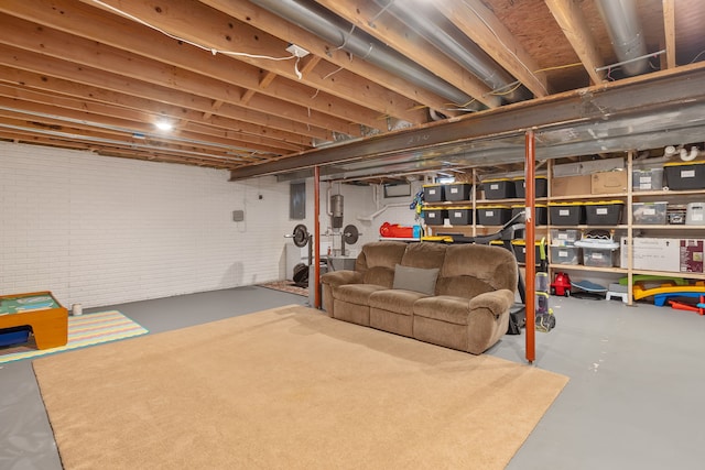 unfinished basement featuring brick wall and electric panel