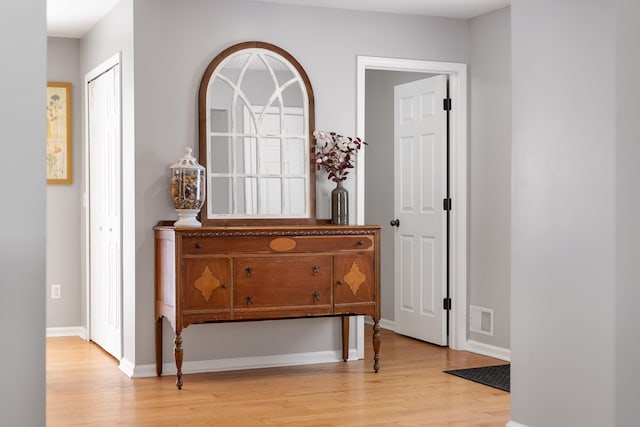 interior space featuring light wood-style floors and baseboards