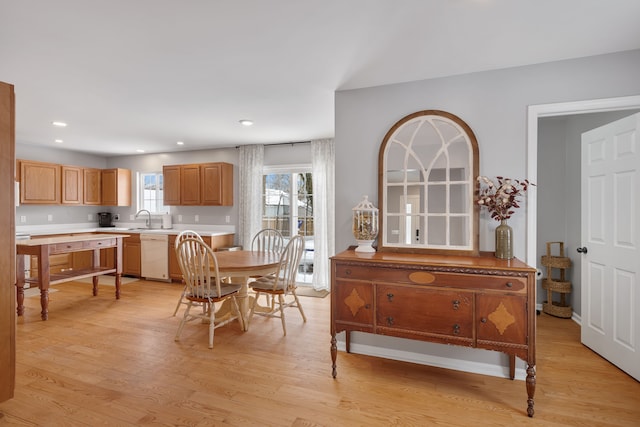 dining room with light wood-style flooring and recessed lighting