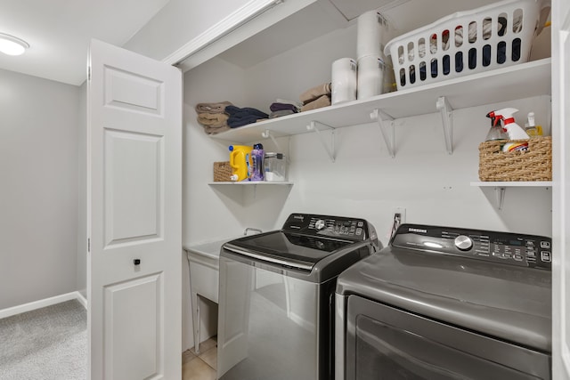 laundry area with laundry area, separate washer and dryer, carpet floors, and baseboards