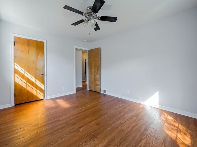 unfurnished bedroom with visible vents, ceiling fan, baseboards, and wood finished floors