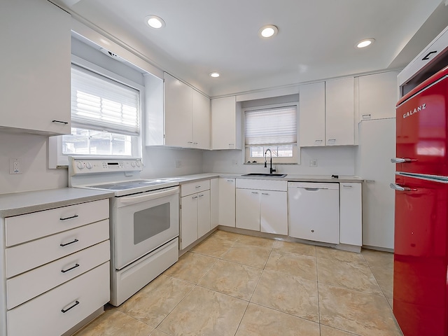 kitchen featuring white appliances, light tile patterned floors, light countertops, white cabinetry, and a sink