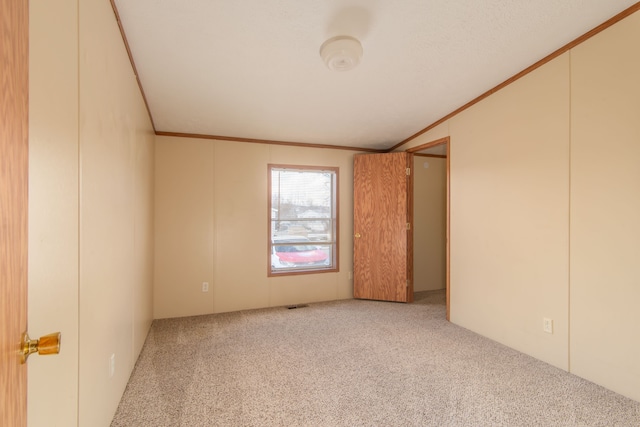 unfurnished bedroom featuring carpet, visible vents, and crown molding