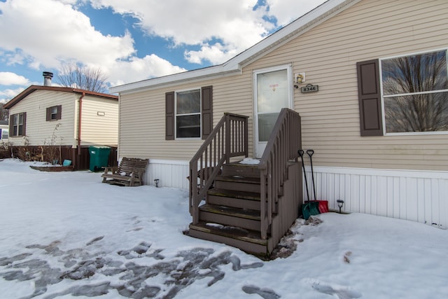 view of snow covered property entrance