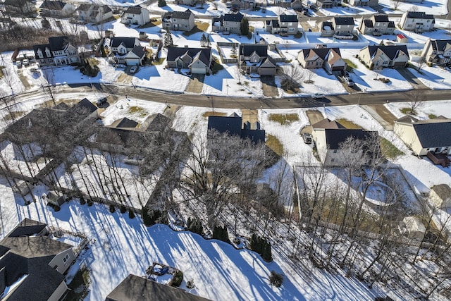 snowy aerial view featuring a residential view